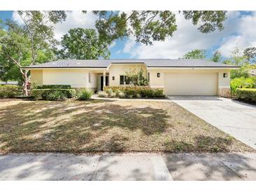 Charming single-story home with manicured landscaping and a welcoming two-car garage at 8506 Shady Glen Dr, Orlando, FL 32819