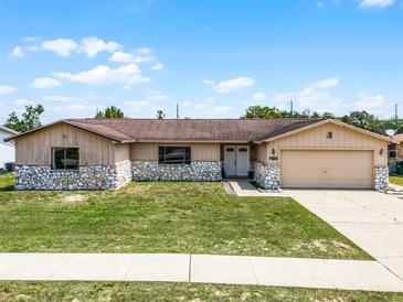 Inviting single-story house showcasing a well-kept front yard and neutral exterior paint at 1132 Feather Dr, Deltona, FL 32725
