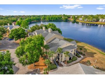 Beautiful waterfront condo building with lush landscaping and stunning lake views at 1065 S Hiawassee Rd # 1436, Orlando, FL 32835