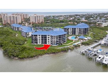 Beautiful aerial view of condo buildings with waterfront access and community pool at 2700 N Peninsula Ave # 314, New Smyrna Beach, FL 32169