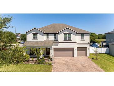 Beautiful two-story home featuring a brick driveway and well-manicured lawn at 3556 Cheswick Dr, Ocoee, FL 34761