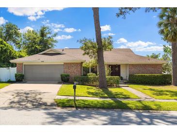Inviting single-story home with a two-car garage, brick accents, and well-maintained landscaping at 400 Woodview Dr, Longwood, FL 32779