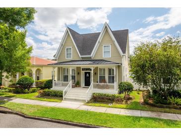 Charming two-story home with a inviting front porch and well-maintained landscaping at 4094 Oak St, Orlando, FL 32814