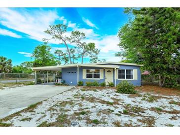 Charming single-story home with a carport, well-maintained landscaping, and a freshly painted exterior at 411 Hibiscus Rd, Casselberry, FL 32707