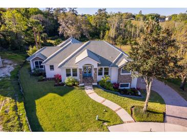 Beautiful single story home with well maintained landscaping and walkway leading to a double door entrance at 516 Sanctuary Golf Pl, Apopka, FL 32712