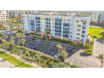 Beautiful multi-story condo with blue balconies and lush tropical landscaping at 5300 S Atlantic Ave # 2-501, New Smyrna Beach, FL 32169