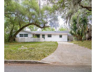 Charming single-story home with a long driveway and beautiful mature trees at 633 Hermits Trail, Altamonte Springs, FL 32701