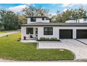 Charming two-story home with a paved driveway, well-manicured lawn and a two car garage at 1000 Farmstead St, Eustis, FL 32736