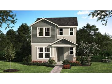 Charming two-story home featuring gray siding, a covered entry, and a well-manicured front lawn at 225 Station Ln, Debary, FL 32713