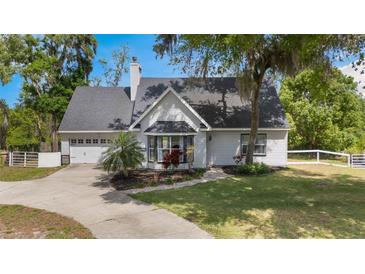 Charming single-Gathering home with a well-manicured lawn, beautiful landscaping, and a two-car attached garage at 30746 Fairview Ave, Tavares, FL 32778