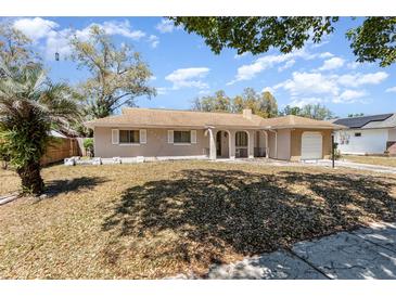 Charming home with a well-maintained front yard and covered entryway at 4723 Cherokee Rose Dr, Orlando, FL 32808