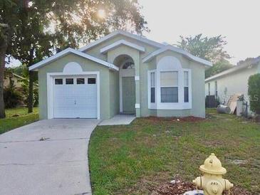 Charming single story home featuring a front-facing garage and well-maintained lawn at 526 Seasons Ct, Winter Springs, FL 32708