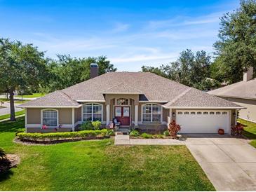 Charming single-story home featuring a well-manicured lawn and a two-car garage at 901 Cornell Ave, Clermont, FL 34711