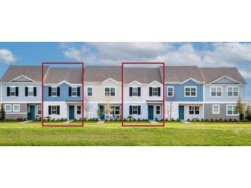 Charming two-story townhome featuring a colorful facade, complemented by well-manicured landscaping at 1476 Silver Lining Way, Apopka, FL 32703