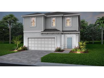 Charming two-story home showcasing a well-manicured lawn, lovely landscaping, and a convenient two-car garage at 15980 Cape Coral Loop, Clermont, FL 34714