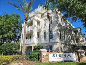 A Siena Celebration condo building featuring multiple stories, balconies and decorative architectural details at 1021 Siena Park E Blvd # 301, Celebration, FL 34747