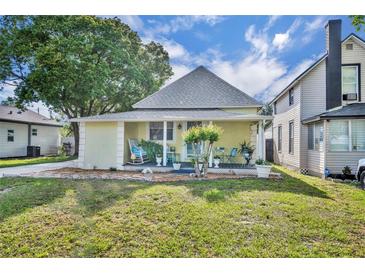 Charming single-Gathering home with a gabled roof and a lovely front porch, set against a bright sky and lush greenery at 1110 Virginia Ave, St Cloud, FL 34769