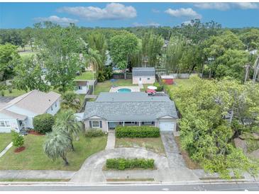Aerial view of a beautiful home with a pool and well-manicured landscaping at 303 W Par St, Orlando, FL 32804