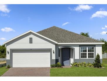 Charming single-Gathering home boasts a two-car garage and a well-manicured lawn at 364 Lemongrass Rd, Minneola, FL 34715