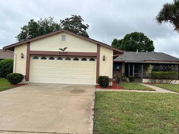 Charming single-story home with a two-car garage and well-maintained landscaping at 5120 Lazy Lake Cir, Orlando, FL 32821
