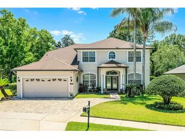Charming two-story home with a brick driveway, well-manicured lawn, and lush landscaping at 772 Pickfair Ter, Lake Mary, FL 32746