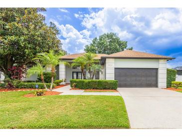 Charming single-Gathering home with lush landscaping and a well-manicured lawn at 8023 Canyon Lake Cir, Orlando, FL 32835