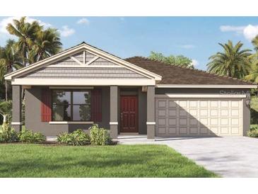 Charming single-story home with a two-car garage and well-manicured front lawn at 1266 Limbali St, Mount Dora, FL 32757