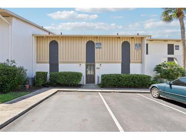 Condo exterior with parking, updated facade, manicured hedges, and convenient unit numbers at 200 Maitland Ave # 52, Altamonte Springs, FL 32701