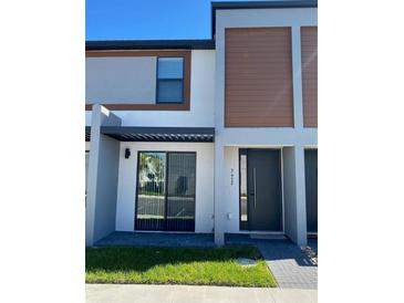 Modern two-story home featuring a contemporary design and neutral color palette at 3432 Tranquil Trl, Kissimmee, FL 34747