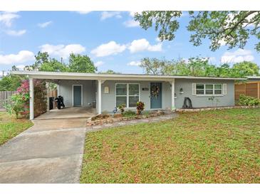 Charming single-story home with a carport, landscaped yard, and inviting curb appeal at 3631 Surrey Dr, Orlando, FL 32812