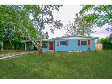 Charming single story home with a lush green lawn, red shutters and door and mature landscaping at 510 Brighton Way, Casselberry, FL 32707