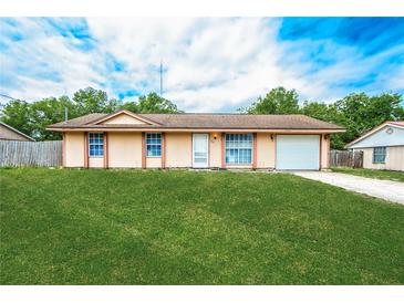 Charming single-story home with a well-maintained lawn and attached one car garage at 855 Third St, Orange City, FL 32763