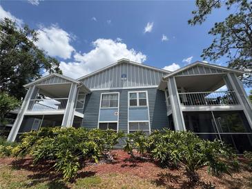 Inviting condo exterior showcasing dual balconies and lush landscaping, perfect for relaxing outdoors at 2608 Grassy Point Dr # 102, Lake Mary, FL 32746