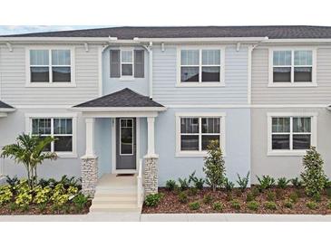 Charming townhome with a welcoming front porch, complemented by neatly manicured landscaping and neutral exterior paint scheme at 1291 Tarflower Dr, Winter Springs, FL 32708