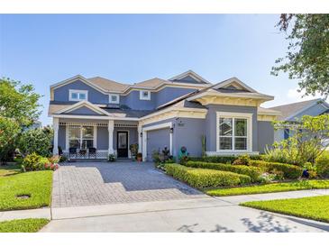 Charming two-story home with landscaped yard and paver driveway at 7837 Bostonian Dr, Winter Garden, FL 34787