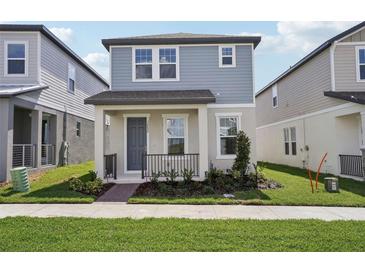 Charming two-story home featuring a covered porch and manicured landscaping at 16484 Silver Brook Way, Winter Garden, FL 34787