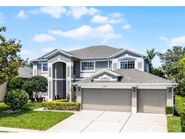 Stunning two-story home featuring a spacious three-car garage and well-manicured front lawn at 10033 Hart Branch Cir, Orlando, FL 32832
