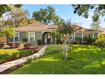 Charming single-story home featuring lush landscaping, a well-manicured lawn, and inviting curb appeal at 109 Romney Marsh Rd, Longwood, FL 32779