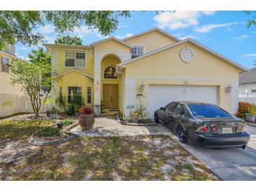 Charming two-story home featuring a well-manicured lawn and attached two-car garage at 1188 Foxforrest Cir, Apopka, FL 32712