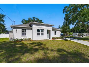 Inviting single-story home featuring a well-manicured lawn and modern architectural details at 1620 Haddock St, St Cloud, FL 34771