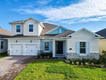 Charming two-story home featuring a three-car garage, beautiful stone accents, and a well-manicured lawn at 19065 Blueleaf St, Orlando, FL 32827