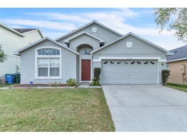 Charming single-Gathering home with a well-maintained lawn and a two-car garage on a sunny day at 2122 Korat Ln, Maitland, FL 32751