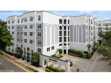 Elegant condo building with manicured landscaping, and gray and white exterior at 300 E South St # 6003, Orlando, FL 32801