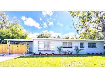 Charming single-story home featuring a spacious yard, carport, and neatly manicured landscaping at 511 S Alder Ave, Orlando, FL 32807
