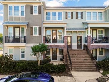 Charming townhome exterior with brick accents, multiple levels, and inviting curb appeal at 861 Taramundi Dr, Oviedo, FL 32765