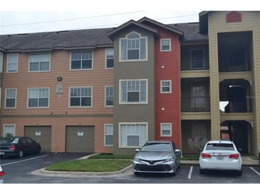 Multi-level condo building with garages and various exterior colors at 2202 Key West Ct # 633, Kissimmee, FL 34741
