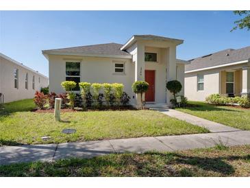 Charming single-story home featuring a well-maintained lawn and colorful landscaping at 2340 Grasmere View S Pkwy, Kissimmee, FL 34746