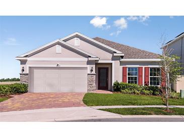 Charming single-story home with a two-car garage, stone accents, and a well-manicured lawn at 3529 Yarian Dr, Haines City, FL 33844