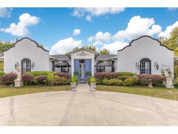 Charming home with striking curb appeal, featuring a well-maintained lawn and unique architectural details at 6816 Greengrove Blvd, Clermont, FL 34714