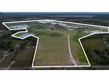 Expansive land parcel with a mix of open fields and natural wetlands, enclosed by a white boundary line at 11320 Montevista Rd, Clermont, FL 34711